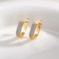 Close-up of geometric pave rhinestone gold huggie earrings detailed shot view showcase - Earrings