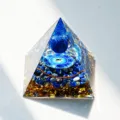Handmade orgonite crystal pyramid ornament with blue crushed stones and resin decor. - AG 3