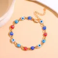 Gold-tone metal chain bracelet featuring colorful evil eye beads, clear main product view. - Multicolor Gold