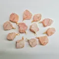 Detail view of handmade wire wrapped rough natural pink quartz crystal stone pendants. - Rose Quartz
