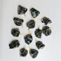Close-up detail of irregular black crystal raw stone pendants with handmade gold wire wrapping. - Obsidian