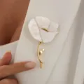 Elegant white flower brooch with gold stem, detailed close-up shot worn on white jacket lapel. - Mother-of-pearl Texture Flower Style (0464) / Gold