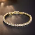 Close-up of gold plated cubic zirconia tennis bracelet, sparkling round stones detail view. - Gold White Zircon