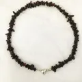 Detail shot of irregular dark red chip beaded choker necklace with silver heart magnetic clasp. - Garnet