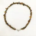 Close-up detail view of irregular natural chip stone beaded necklace with a magnetic heart clasp. - Tiger's Eye