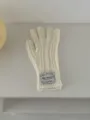 Cozy cable knit gloves in off white featuring warm wool fabric and a stylish wrist label design. - One Size / White