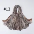 Detail view of the soft gradient silk-feel scarf, lightweight fabric texture close up. - Style #12
