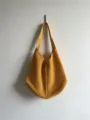 Detailed view of the yellow crochet shoulder tote bag showing its hollow-out knit texture. - Yellow