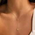 Gros plan détaillé d'un collier en Y doré délicat avec pendentif goutte sur le cou. - Style Chaîne Fine Goutte d'Eau Strass (Style 6)