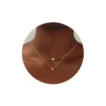 Vista detallada del collar multicapa dorado con colgantes de corazón y letra V puestos. - Letra V
