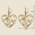 Gold heart drop earrings with dried flowers resin and metallic rim for women fashion style - Gypsophila