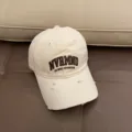 Close-up detail of the distressed soft top baseball cap with embroidery lettering. - Adjustable 55-59cm / Off White