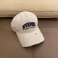 Close-up of distressed beige baseball cap with embroidery detail for casual wear. - Adjustable 55-59cm / Milky White