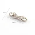 Detailed close-up view of a delicate silver-colored bow-shaped jewelry connector with sparkling stones. - Gold Base White Rhinestone