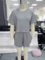 Detailed view of women black white striped knit pajama set short sleeve top and shorts. - Front View