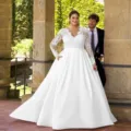 Plus size long sleeve lace satin wedding dress with V-neck and elegant sweep train for brides. - 26W / Dresses / White