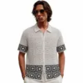 Detailed view of men's black and white contrast crochet knit polo shirt cardigan with pattern. - M / Tops / White