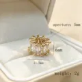 Detailed shot of gold plated cubic zirconia wheel charm spacer bead showing clarity and size. - Gold White Zirconia