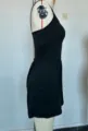 Side view detail of a black sleeveless strapless romper jumpsuit, showing slim fit and side design. - XS / Side View