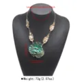 Detailed close-up of the exaggerated green layered flower pendant necklace with gold leaves. - 3D Floral Necklace (N14268) / Green