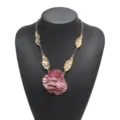 Exquisite 3d flower pendant and gold leaf detail on metallic chain necklace close-up view. - Pink