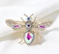 Close-up of a vintage rhinestone crystal bee brooch, detailed metallic texture and sparkle. - AB Color