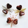 Natural stone insect figurine variant with heart-shaped crystal wings and metal body - Gold / Mahogany Obsidian