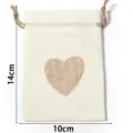 Linen drawstring pouch detail view showcasing the cute heart pattern and size dimensions. - 10x14cm / Off-white Heart