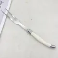 Stainless steel carving fork with ivory handle, perfect for western dining and BBQ meat serving. - Steak Fork / White
