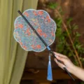 Traditional Chinese Hanfu round fan with exquisite brocade fabric pattern and blue tassel. - 8-Petal Sky Blue Waist Fan (Bamboo Edge)