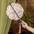 Traditional Chinese hand fan with bamboo handle and pink tassel, elegant Hanfu accessory style. - 8-Petal Fenyao Waist Fan (Bamboo Edge)