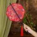 Traditional Chinese Hanfu folding fan with red tassel, elegant bamboo handle design SKU - 8-Petal Cinnabar Tangerine Waist Fan (Bamboo Edge)
