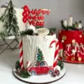 Detailed view of the red 2027 Happy New Year acrylic cake topper close up shot detail. - Red Gold Balloon 2027