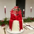 New Year 2027 acrylic cake topper detail shot, festive red bow cake decoration props display. - Bow 2027