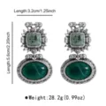 Vintage retro green stone drop earrings with ornate metal detailing, elegant statement jewelry. - Earrings / Green