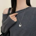 Korean minimalist silver long necklace with unique pendant, elegant sweater chain accessory. - Bag Chain Necklace / Silver