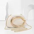 Elegant cream clutch bag with golden metal handle and chain strap for evening parties. - Off White