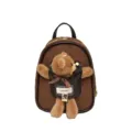 Small brown suede backpack with a plush teddy bear charm, black trim, and gold-tone hardware - Coffee