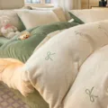 Embroidered milk velvet four-piece bedding set with "hui xuan" bow - creamy white & green