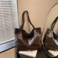 Brown faux leather tote bag with a glossy finish, twin shoulder straps, and stud accents - No Pendant / Brown