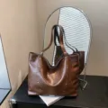 Brown faux leather tote bag with rivet accents and long handles, shown in a spacious upright shape - No Pendant / Brown