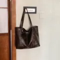 Large dark brown faux leather tote with double shoulder straps, rivet details and a plush charm - With Pendant / Coffee