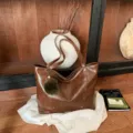 Large brown faux leather tote with stud details, double handles and a green pom-pom charm - With Pendant / Brown