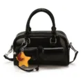 Detail of black faux leather with twin front flap pockets, metal hardware and star-moon charm - With Pendant / Black