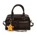 Front view of a glossy brown bag with twin handles, two pockets, zipper and yellow star charm - With Pendant / Coffee Brown