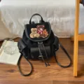 Black suede backpack with teddy bear appliqué, leather flap, drawstring closure and shoulder straps - 22*12*24cm / Black