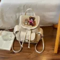 Beige suede backpack with teddy bear embroidery, drawstring flap and buckle pockets - 22*12*24cm / Off White