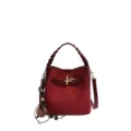 Red suede-textured bag showing a braided handle, gold-tone buckle and dangling charm on white - Burgundy