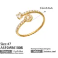 Close-up of an open gold-tone ring with clear stones and a round pavé cluster on a white background - Round Style (A639) / Size 7 / Gold