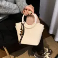 Ivory woven bucket handbag with round handles, wood bead charm and detachable shoulder strap - With Pendant / Off White